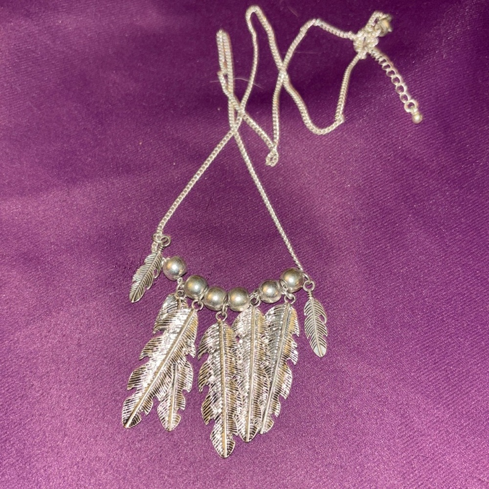 Long silver beaded necklace with feathers